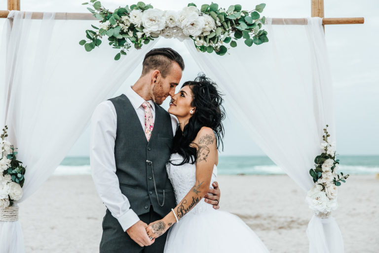 Miami Beach Wedding Bride and Groom Under a 2 Post Arbor about to Kiss