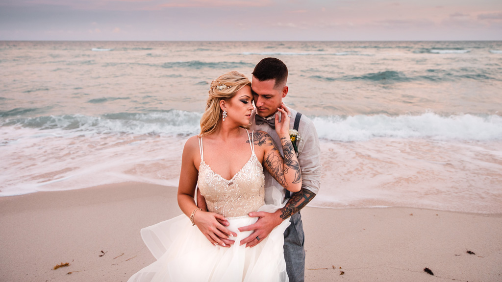 A Miami Beach Wedding Bride and Groom with Tattoos Embracing and posing for picture