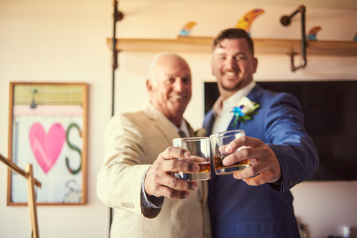 Groom and his father toast with whiskey before the wedding - Plunge Beach Resort