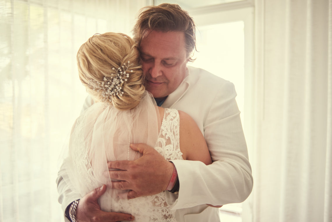 Father hugs bride at Plunge Beach Resort