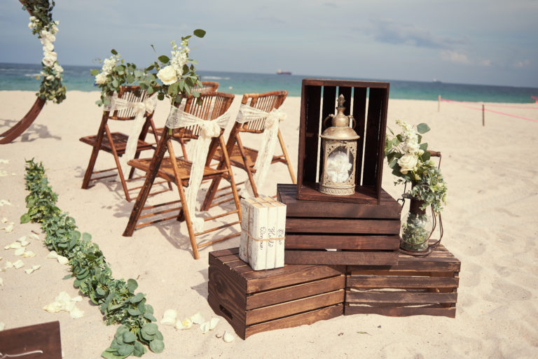 Beach Wedding Chairs with greenery accents