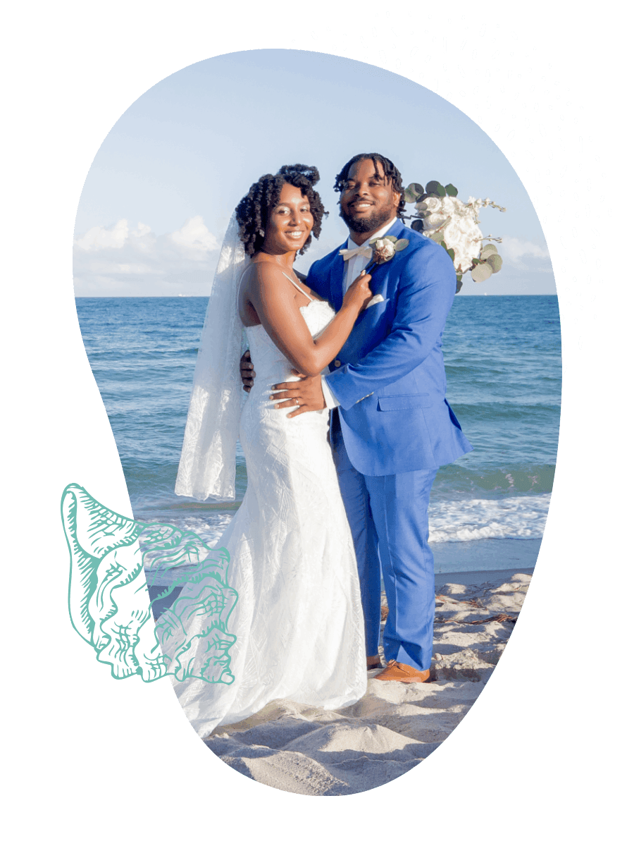 Bride and groom standing on the beach