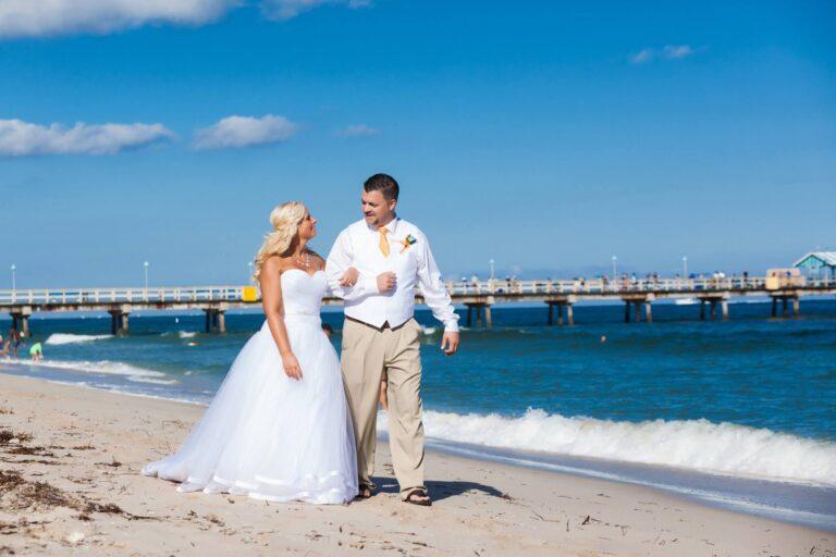 Bride and groom stroll on the beach - Lauderdale-by-the-Sea