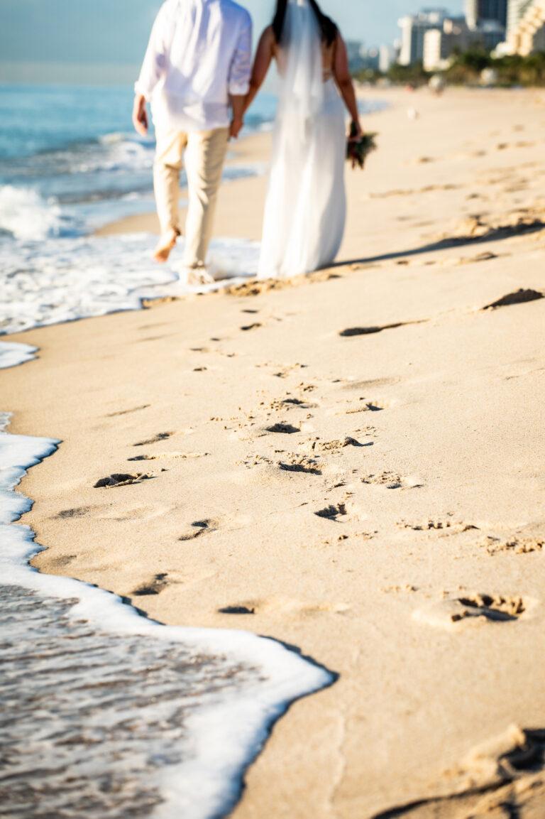affordable pompano beach wedding couple walking on shoreline